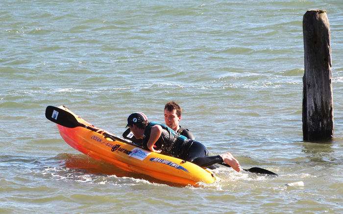A quick recovery from a capsize as one kayak sets off