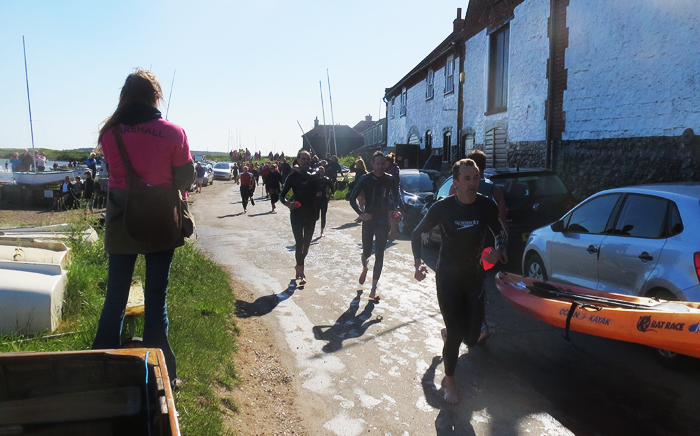 Completed swimmers run to fetch their kayaks