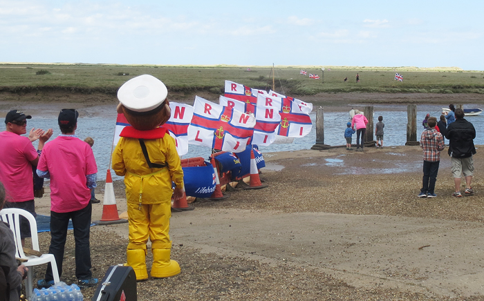 The finish line as the first finishers run over the marsh and through the channel