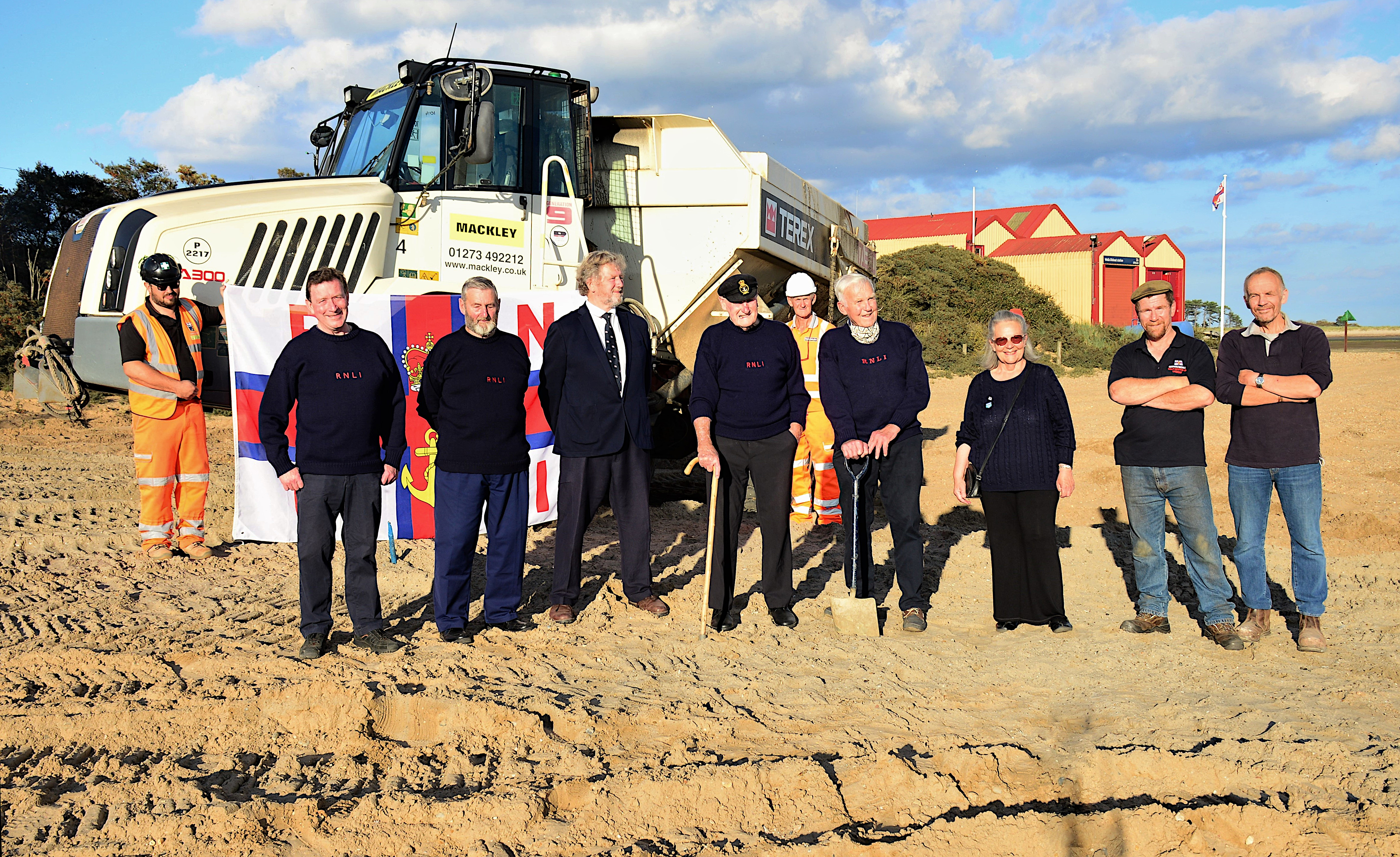 Lifeboat crew and management volunteers on the beach at the start of building work