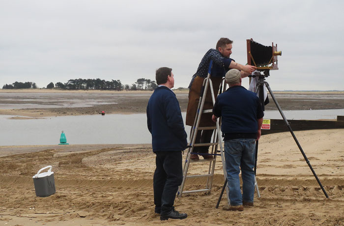 Jack composing his photograph, with a steadying hand from coxswain Allen Frary