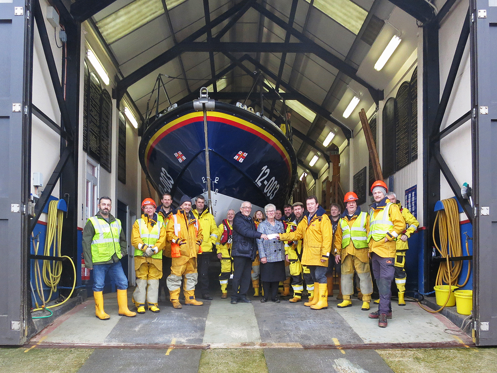 George Gray from Gressenhall Social Club presents a cheque to lifeboat operations Manager Chris Hardy before the practice launch