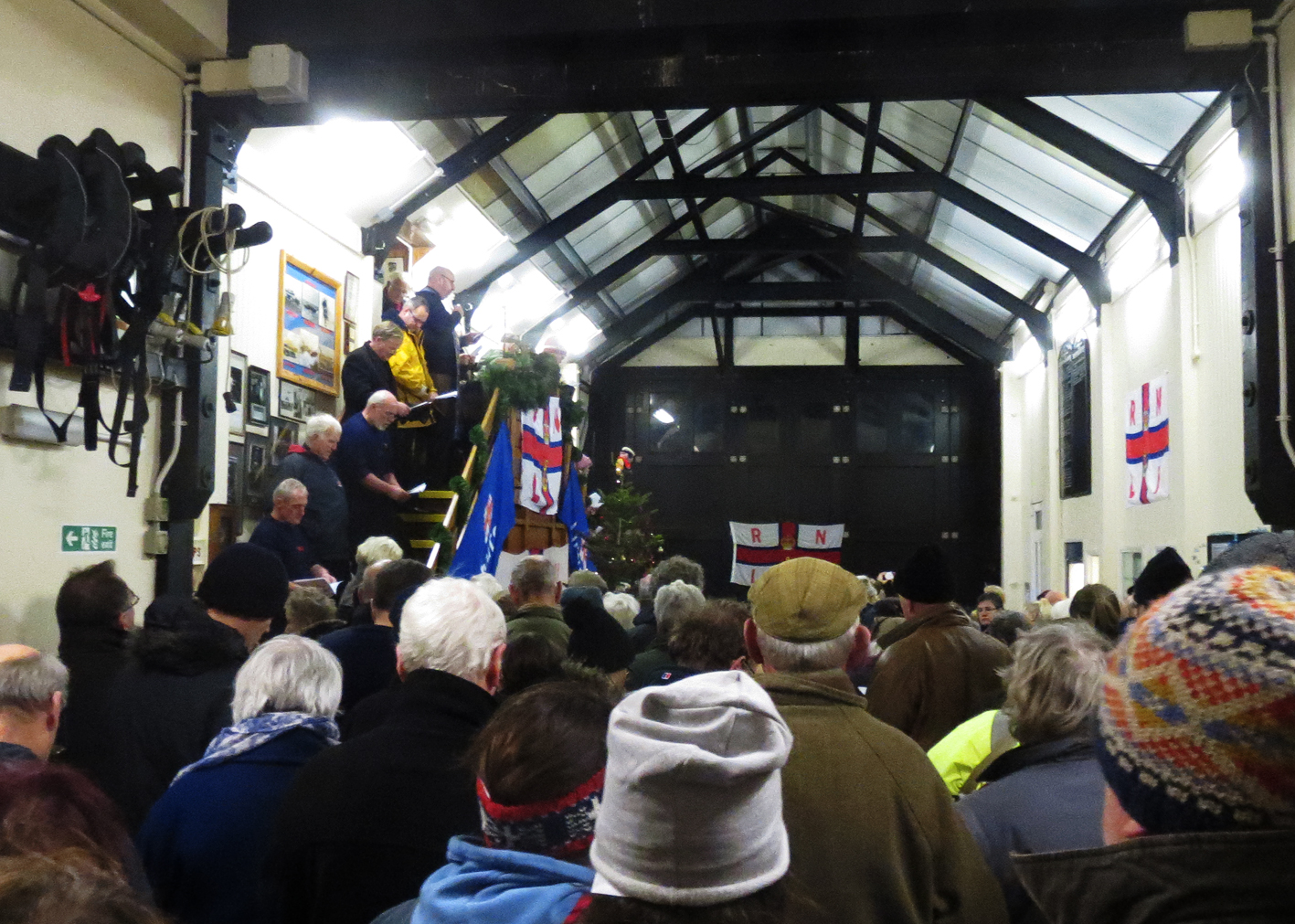 Rev. Woodruff addresses a packed boat hall at the carol service