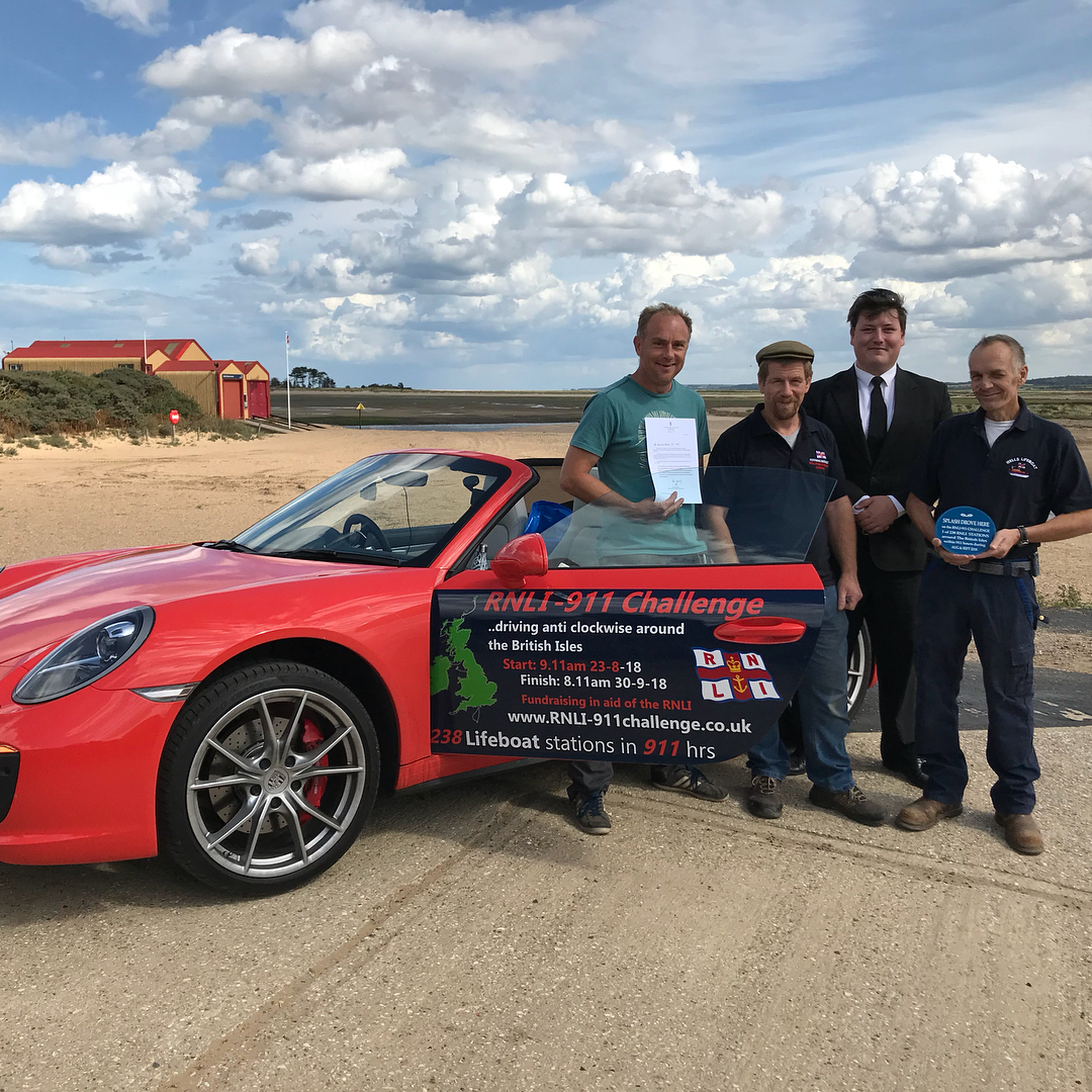 Wells Crew members with the 911 Challenge Porsche on its brief stopover in Wells en-route to all 238 RNLI lifeboat stations