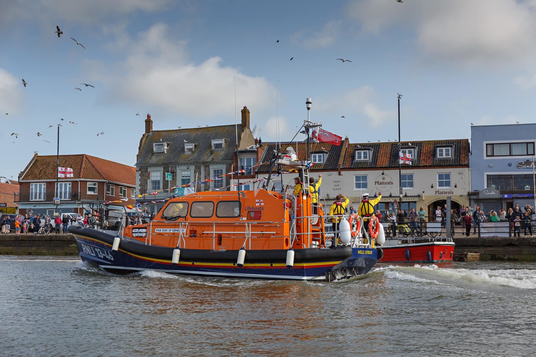 The newly named lifeboat arriving at the quay for a public dedication and celebration