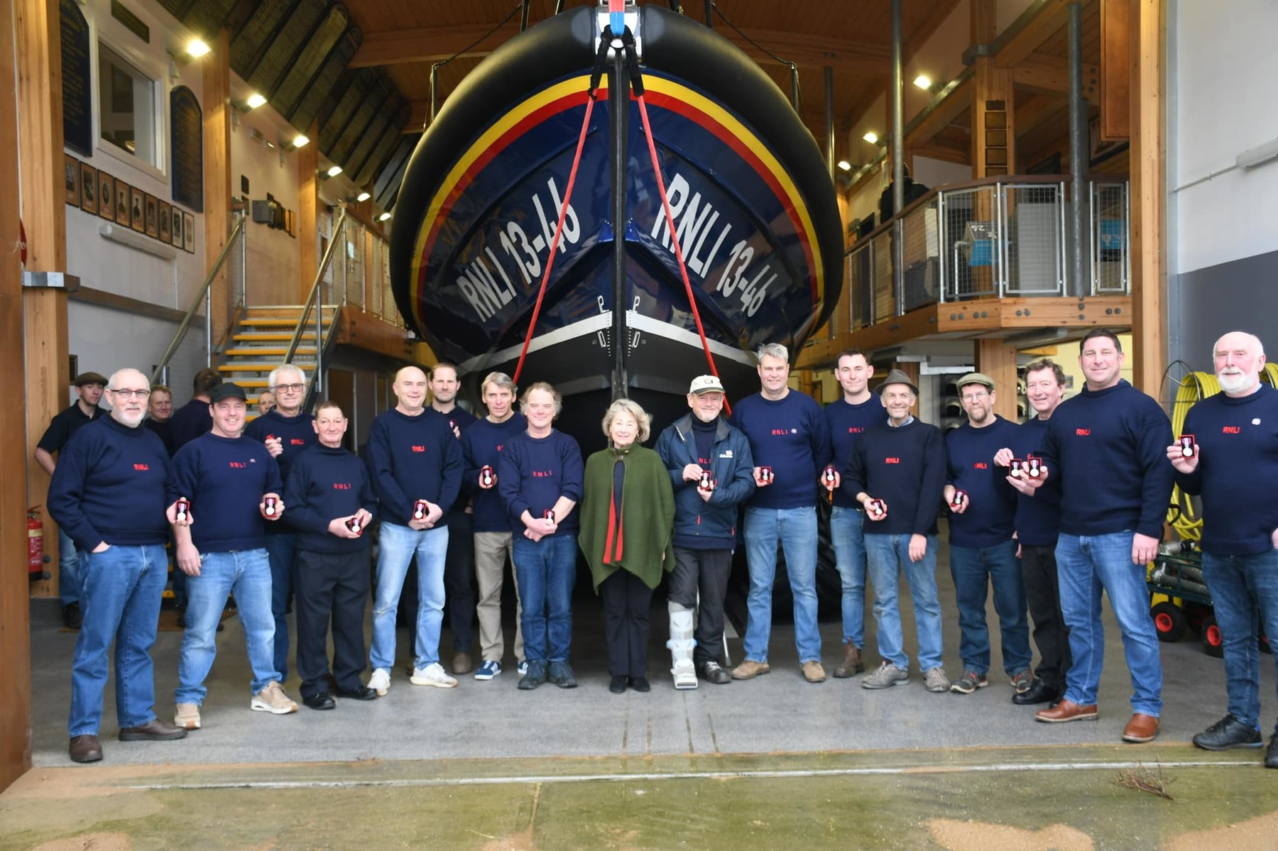 Sarah, Countess of Leicester with the crew and newly presented Coronation medals 