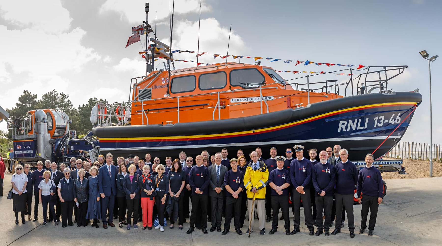 HRH The Duke of Kent (yellow jacket) with VIP guests and the crew at the naming of the new lifeboat