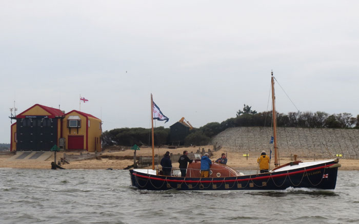Lucy Lavers passes Wells boathouse on 4 May 15 where she served as relief boat
