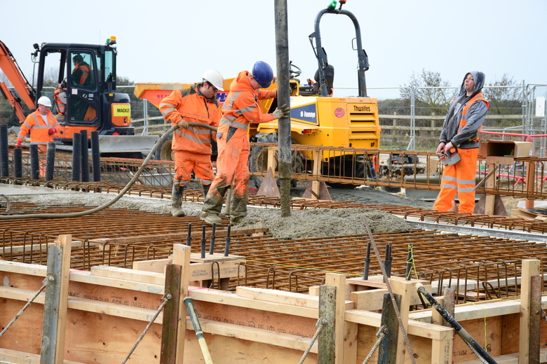 Pouring concrete for the building slab