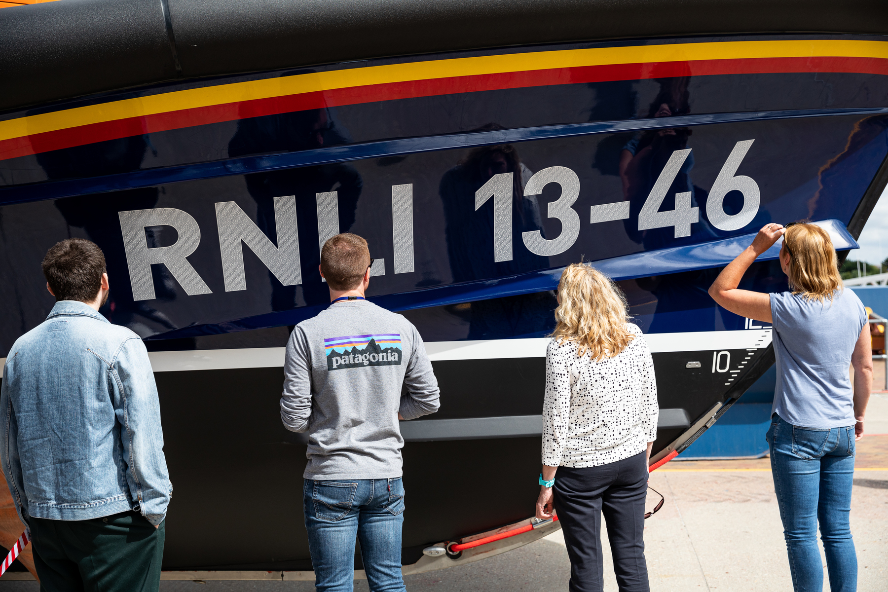 Viewing the Launch A Memory names celebrated within the 13-46 decals on the boat