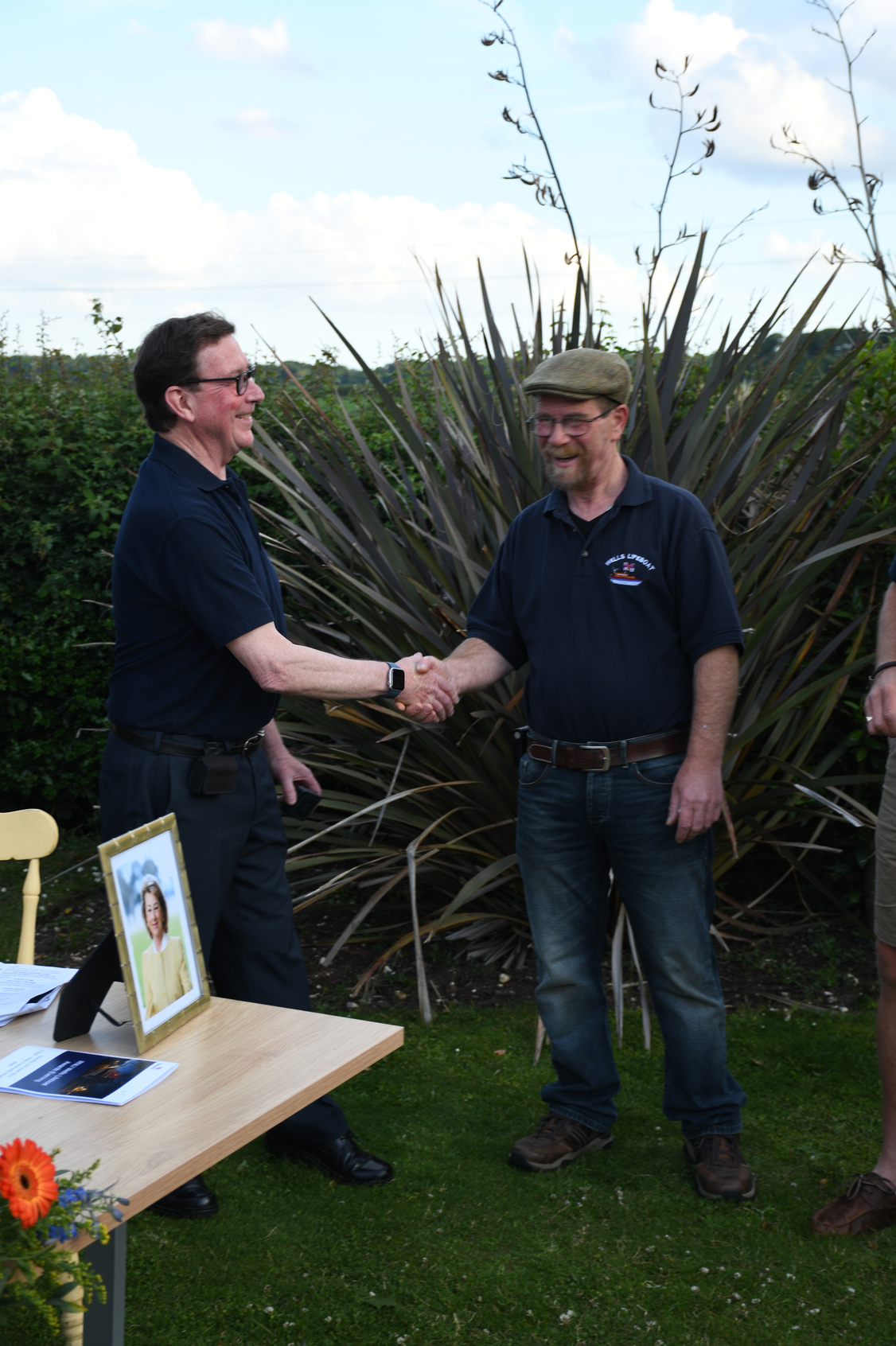 Lifeboat Operations Manager Chris Hardy (l) presented with 20 year service award by Coxswain Nicky King (r)