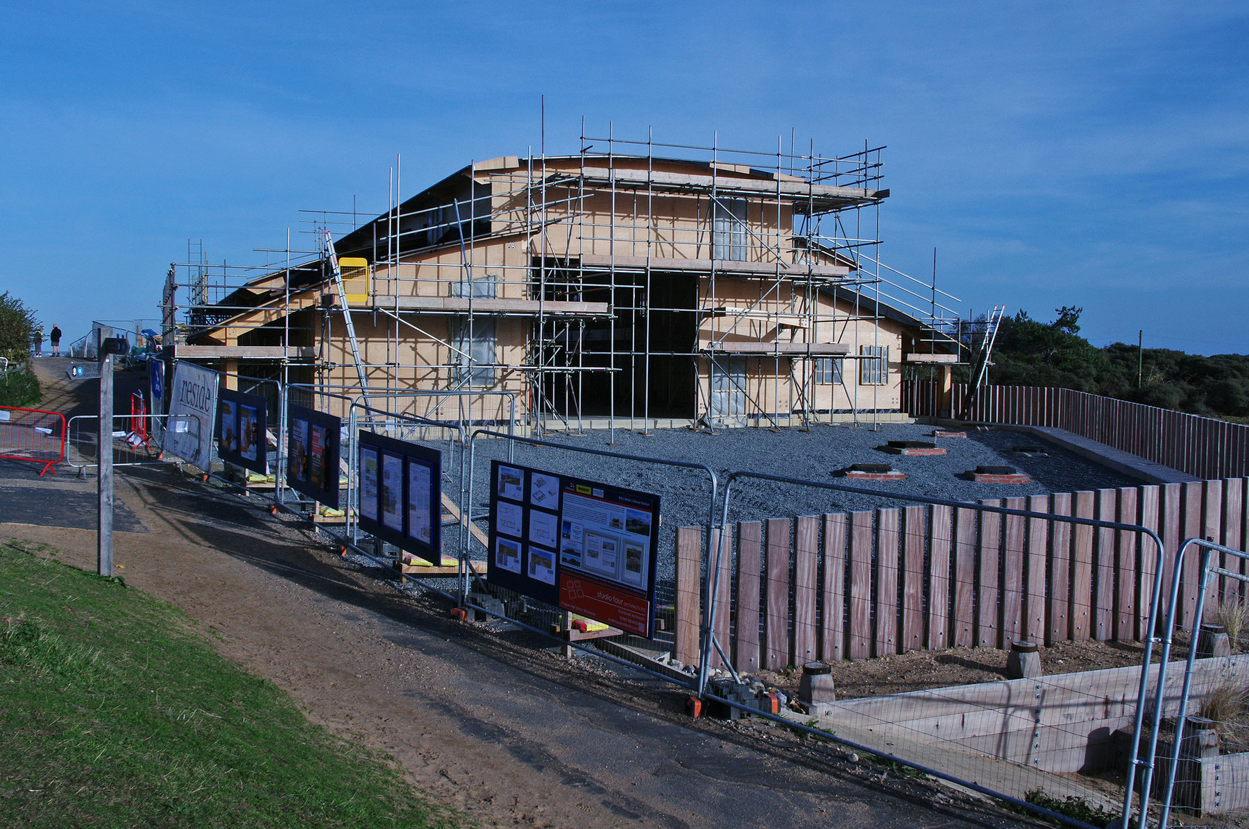 Site view with new signs and information boards along the beach bank path