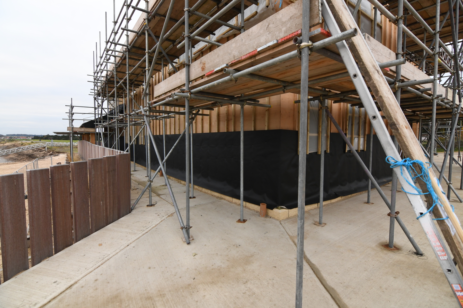 Insulating layer being added to external walls on north-east corner of building