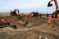 Lifting the cross piece for the final set of piles into the hole