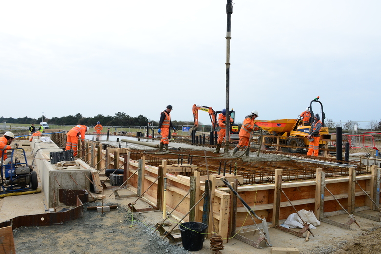 Pouring concrete for the building slab