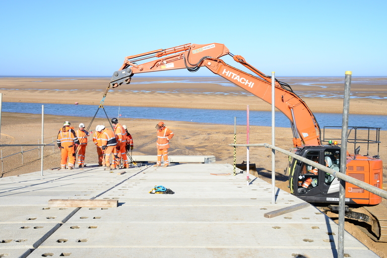 Lifting precast concrete planks into place on the ALB ramp