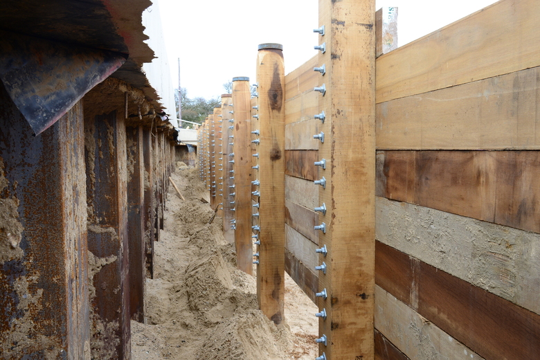 Between the sheet piling and capping beam and the timber works