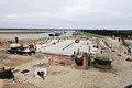 Outline of building starting to appear above the concrete slab