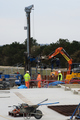 Drilling rig being used for installation of the ground-sourced heat pump