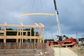 Remaining boat hall roof beams being lifted into place