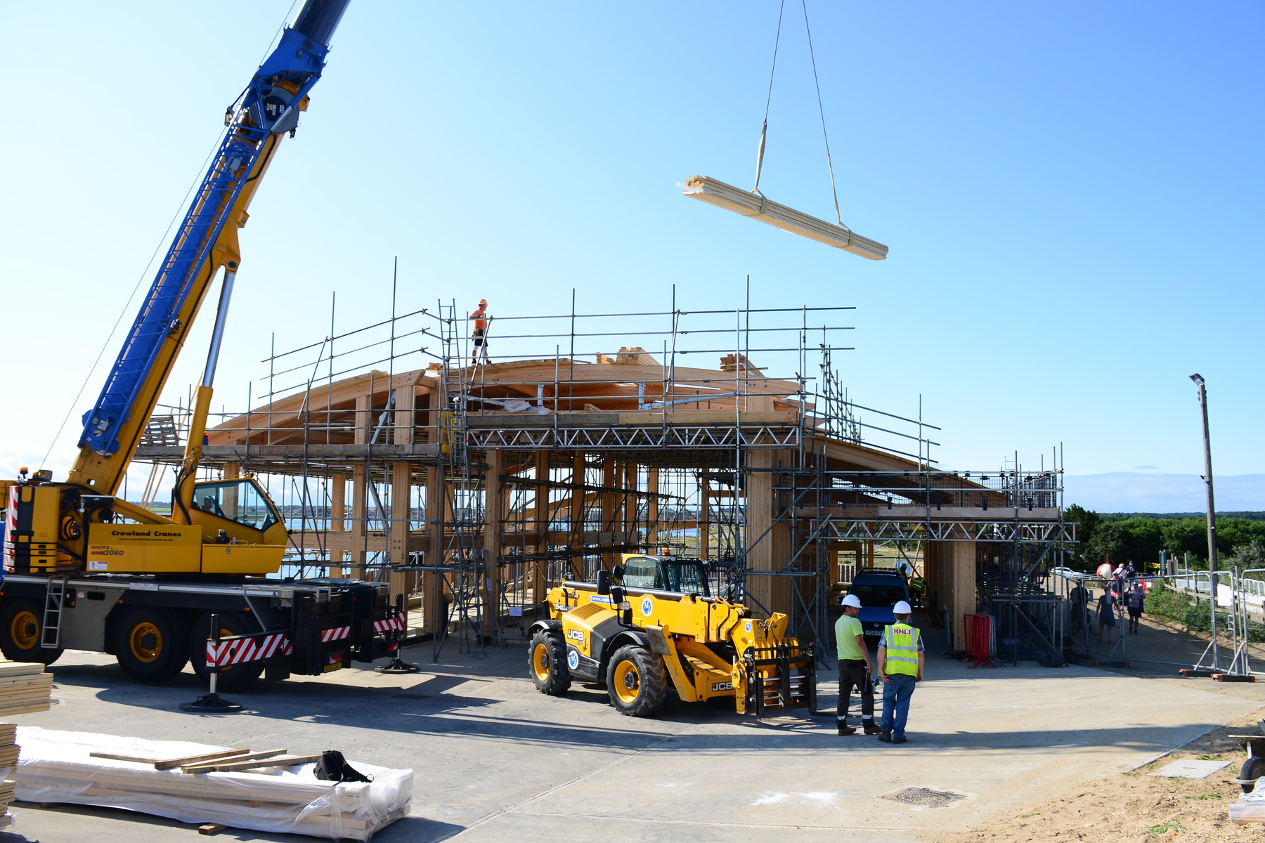 Craning planks onto the boathouse roof