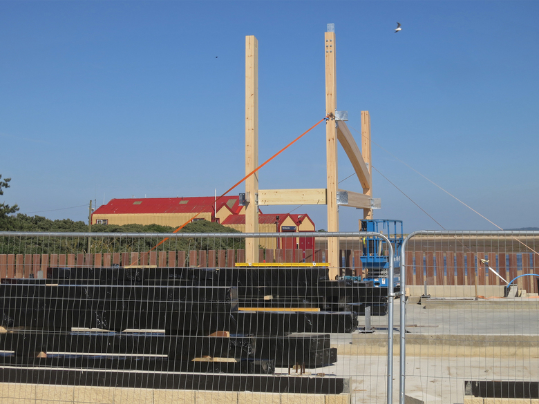 Start of the frame for the new boathouse... with the old boathouse behind