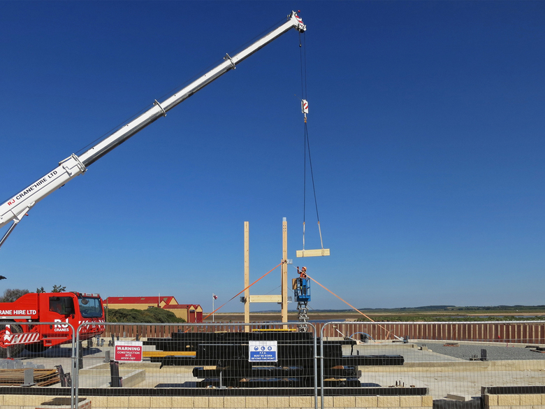 Beams being lifted and bolted into place