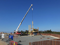 Quick progress lifting frame pieces into position in what will be the workshop area of the building