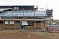 Panelled roof and blockwork walls in place around gift shop and public entrance