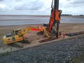 First pile for the ramp being driven into the beach