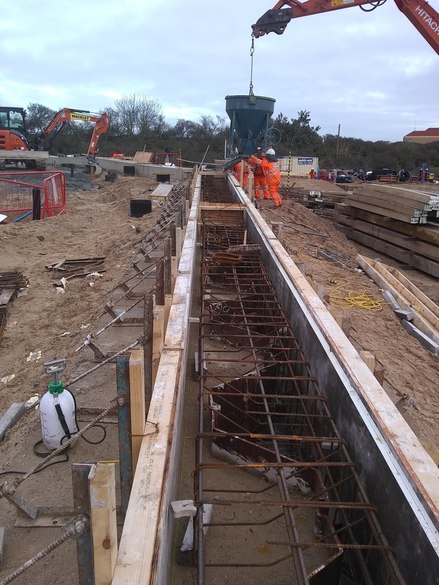 Pouring concrete for the capping beam towards the southern end of the building