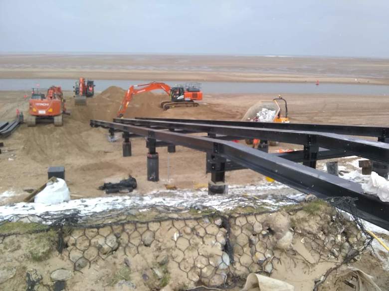 Digging out the lower end of the ramp so steelwork can be installed on the piles