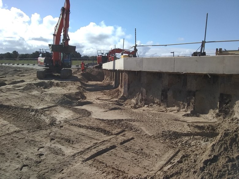 Sheet piling and capping beam at perimeter of site exposed ready for timber installation