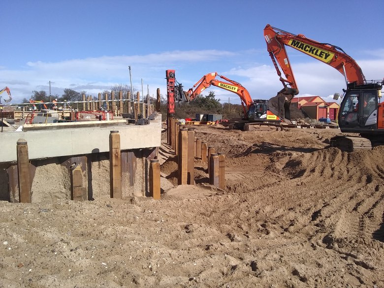 Installing timber piles around the edge of the site