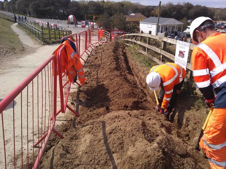 Hand-digging a trench for the electricity supply to the station