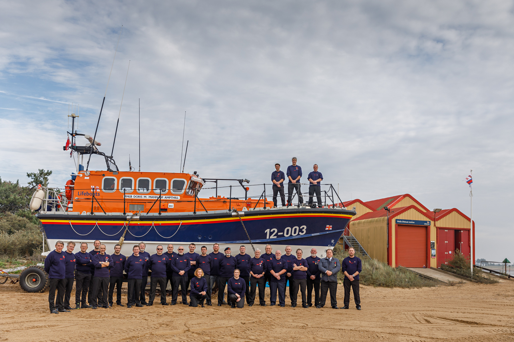 12-003 with crew and launchers past and present beside the 1985 boathouse