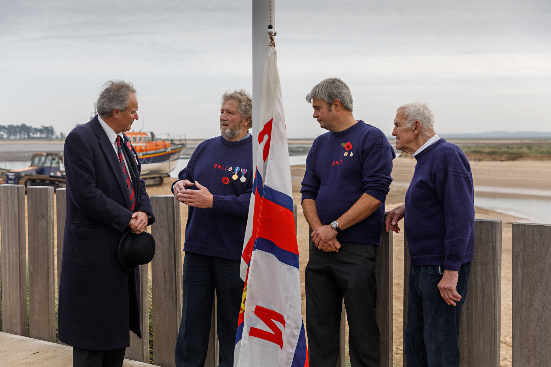 Lord Leicester, Peter Rainsford, Martin Emerson and Richard Cracknell wait to raise it on the new boathouse 13 minutes 46 seconds later