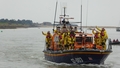 A crowded Mersey lifeboat arriving at the quaysude