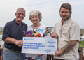 Coxswain Allen Frary (l) with Jill and Kieron Scillitoe presenting cheque for sky dive