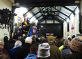 Rev. Neil Woodruff addresses a packed boathouse at the carol service, 14 December 2014