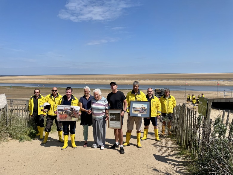 Fiona, Dorothy and Rob MacCallum with the crew and some of Campbell's photographs from the boathouse