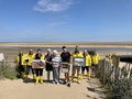 Fiona, Dorothy and Rob MacCallum with the crew and some of Campbell's photographs from the boathouse