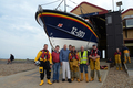 The late Campbell MacCallum (center, blue top) visiting the boathouse in 2018