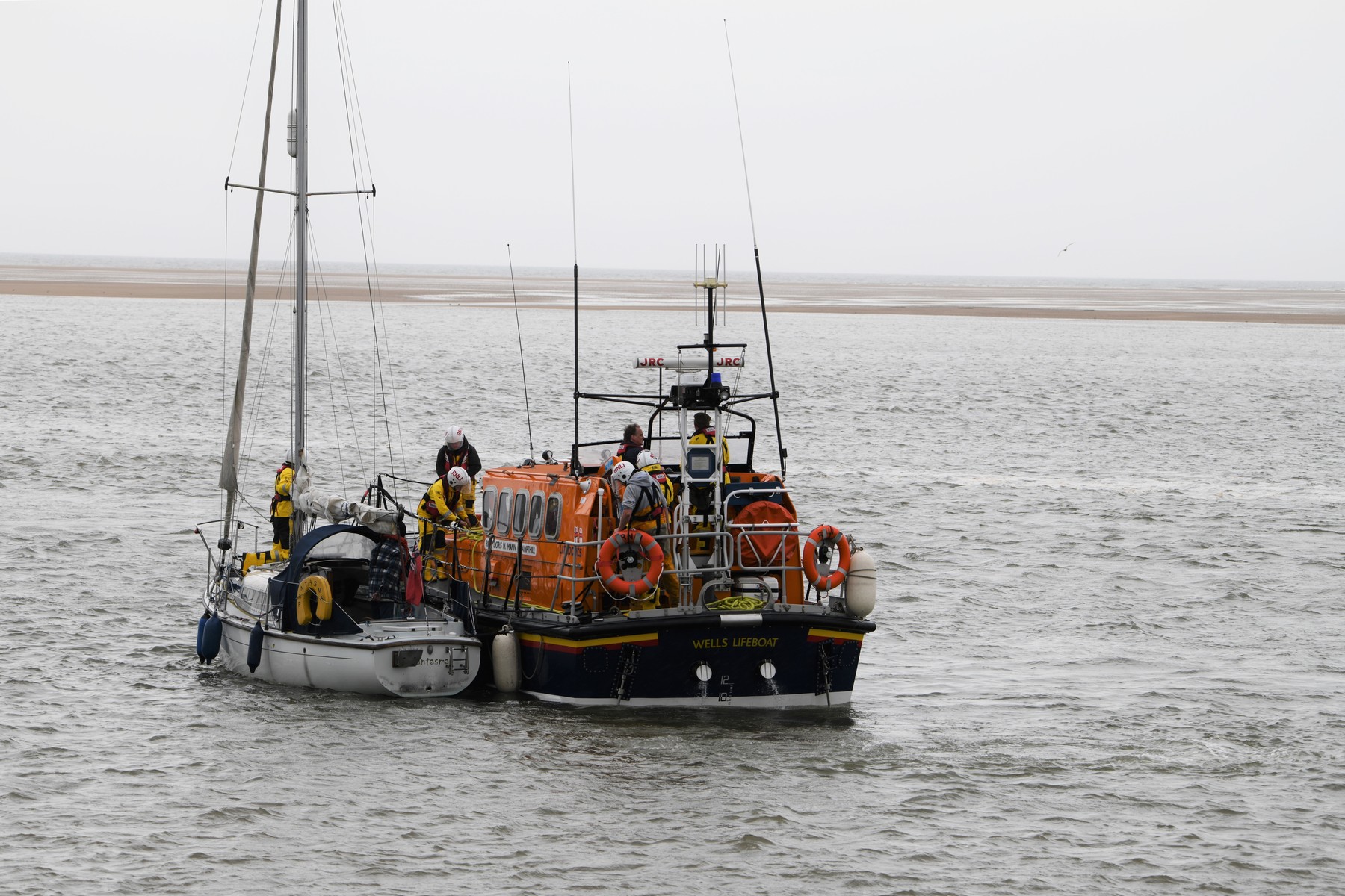 Off Wells beach, the yacht is brought alongside the lifeboat prior to being safely berthed, 15/5/22