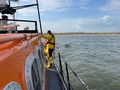 Bow of sunken speedboat showing just above the water, off Brancaster