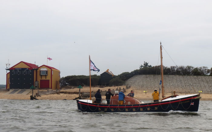 Lucy Lavers passes Wells boathouse on 4 May 15 where she served as relief boat in 1962 and 1963-64